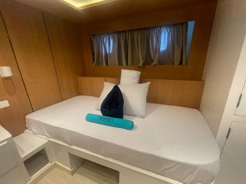 Double cabin with made bed and wood panelling