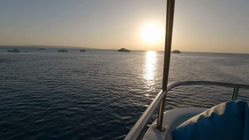 Sunset over the sea from the yacht rail