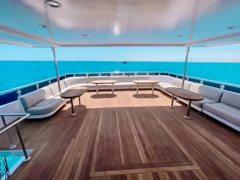 Shaded sun deck with sofas and tables