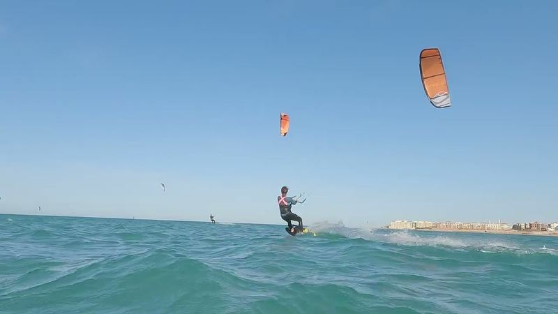 Kiter with an orange kite on the choppy water off Hurghada