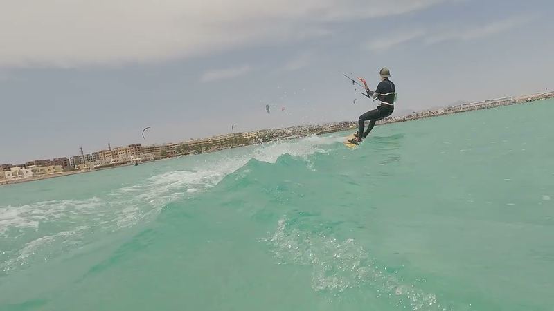 Kiter on turquoise water with the Hurghada hotel coast behind