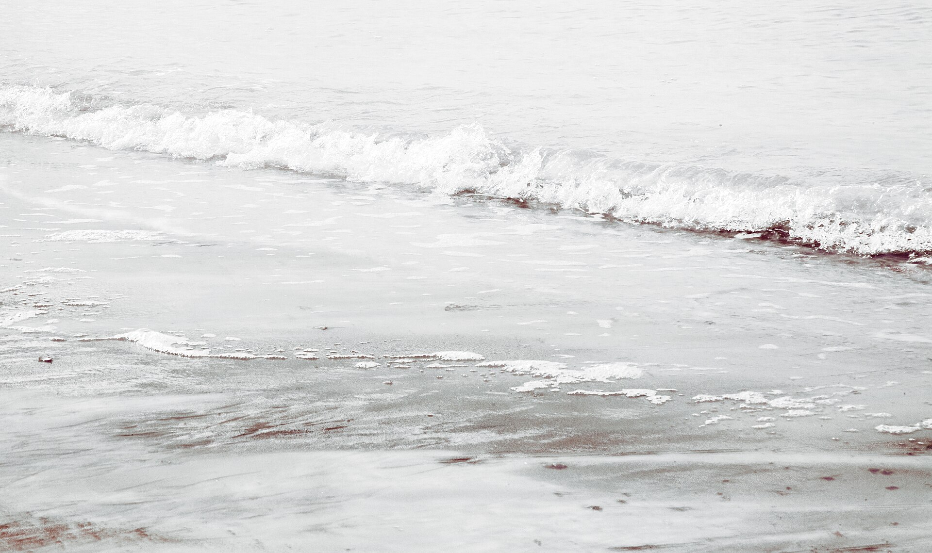 Small wave washing on beach (Unsplash)