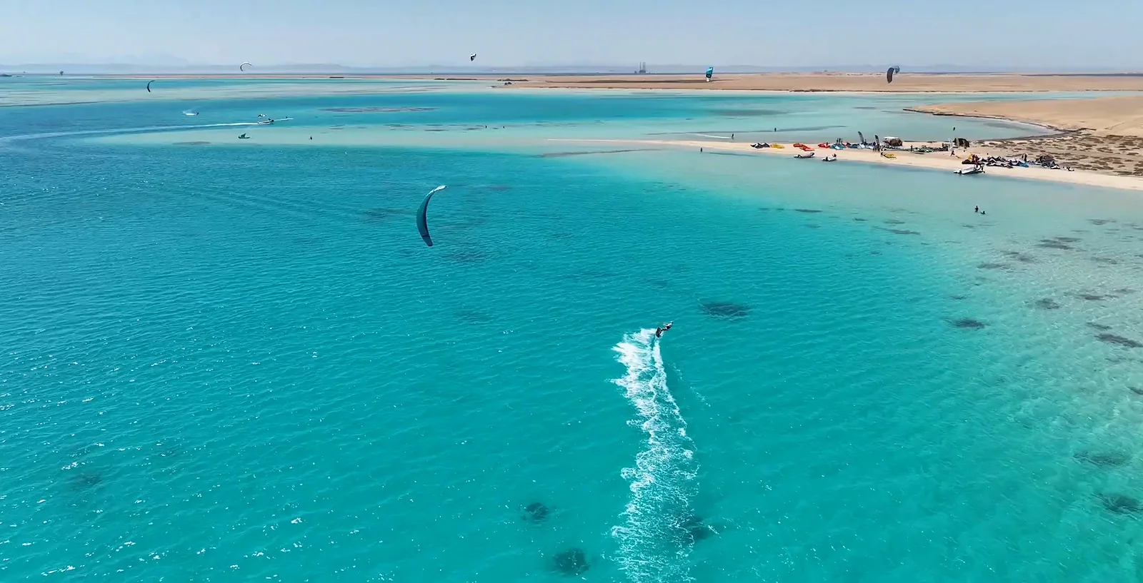 A kiter in a shallow lagoon by a sandbank